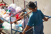 Carrinheiro carrega o filho junto com o lixo recolhido nas ruas. Foto Murilo Roso. Maio de 2008.